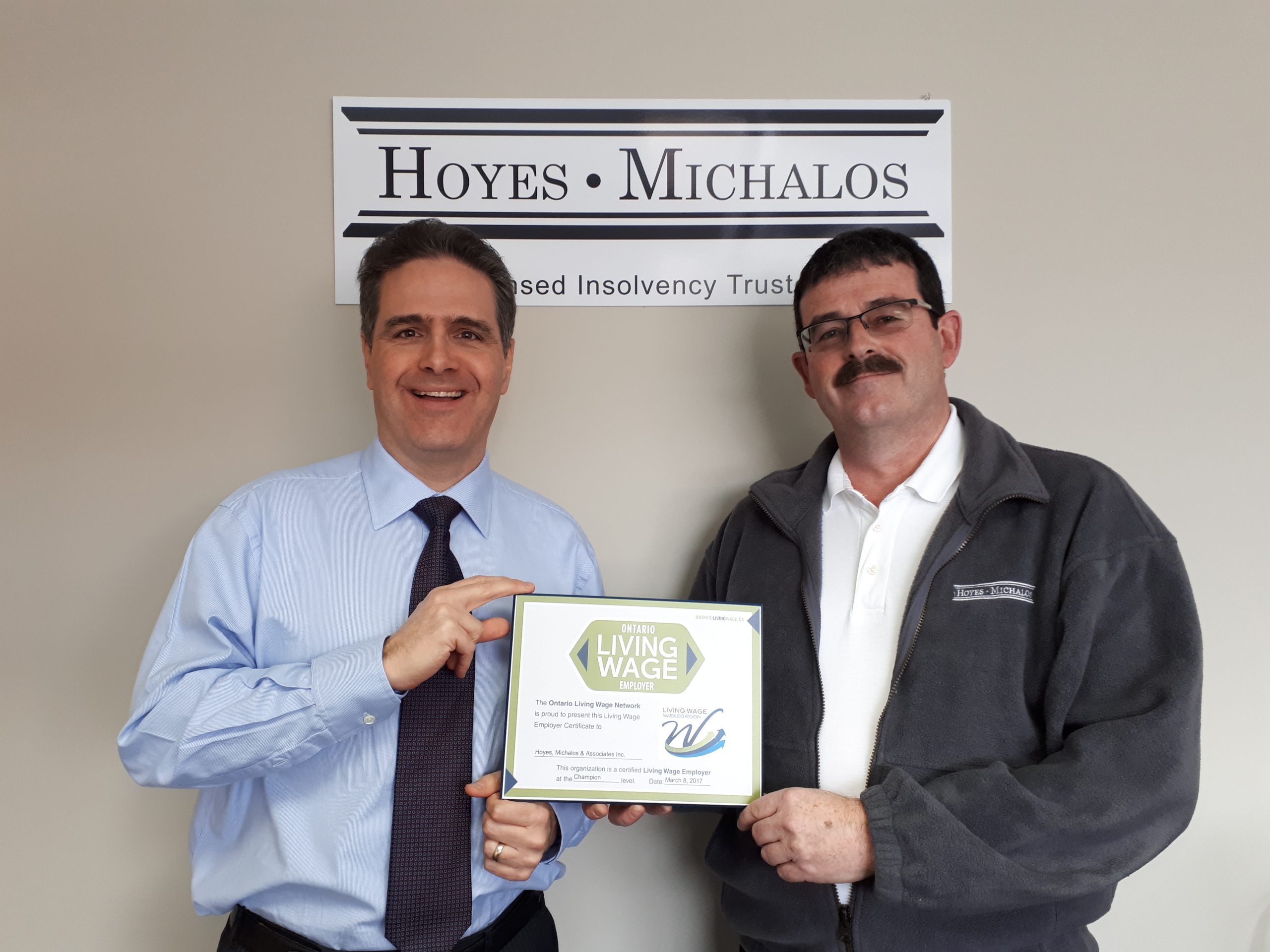 Doug Hoyes and Ted Michalos holding Living Wage plaque