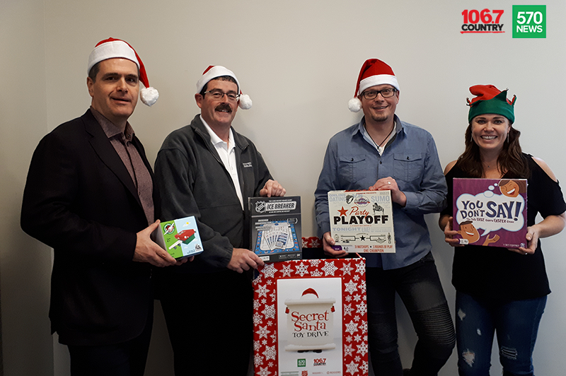 Doug Hoyes, Ted Michalos and 570 News radio crew posing for Secret Santa sponsorship